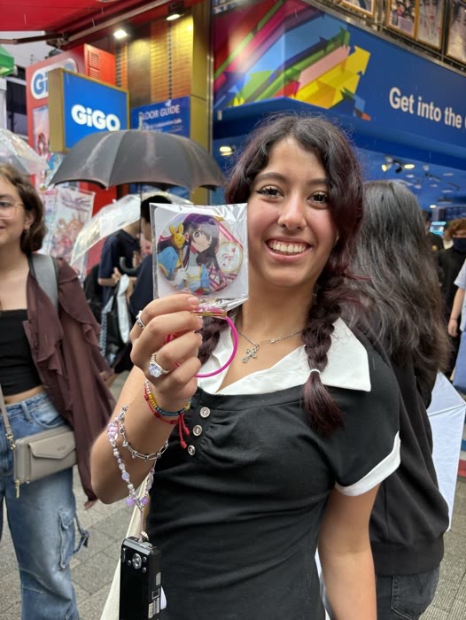 A guest beaming with the anime badge she just found