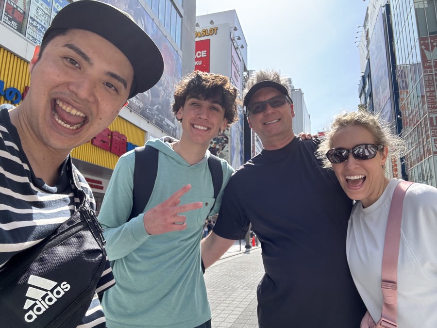 Your guide meeting guests on a sunny Akihabara street